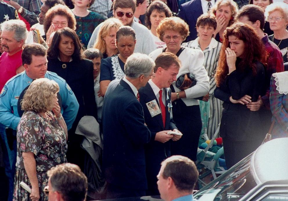 PHOTO: Grief-stricken David Smith (wearing red tie & pic of sons on lapel) weeps amidst a crowd of mourners as he leaves funeral for his kids Michael & Alex.