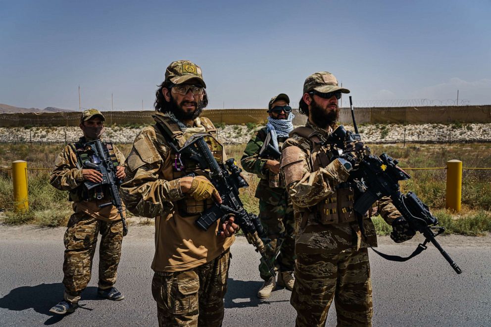 PHOTO: In this Aug. 29, 2021, file photo, Taliban fighters armed with American weapons and equipment patrol and secure the outer perimeter, near the American controlled side of the Hamid Karzai International Airport in Kabul, Afghanistan.
