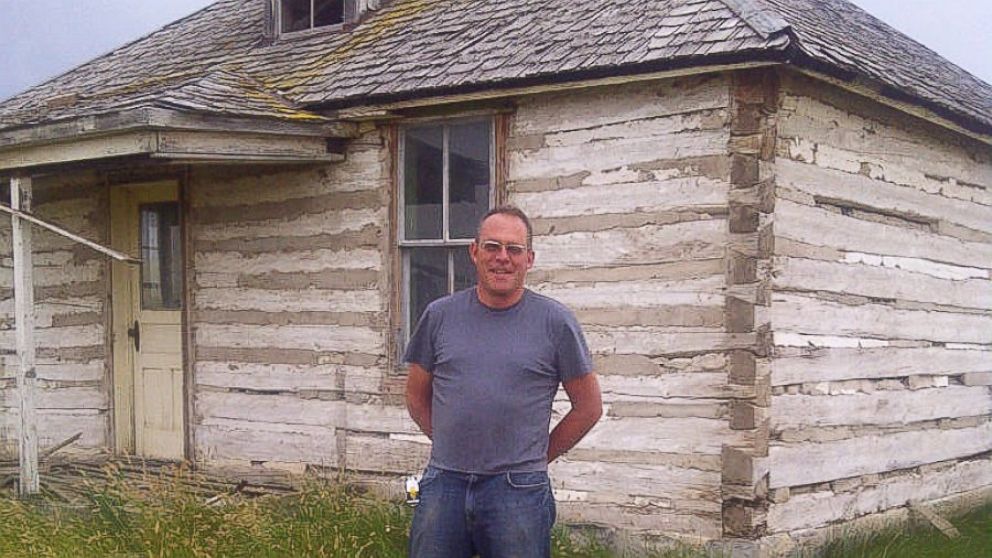 Karl Beckmann stands in front of one two century-old log cabins from Montana where they were disassembled and carted to Vallejo in preparation of being installed at Twitter’s headquarters.