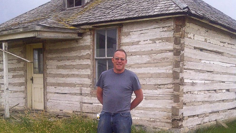 Karl Beckmann stands in front of one two century-old log cabins from Montana where they were disassembled and carted to Vallejo in preparation of being installed at Twitter’s headquarters. 