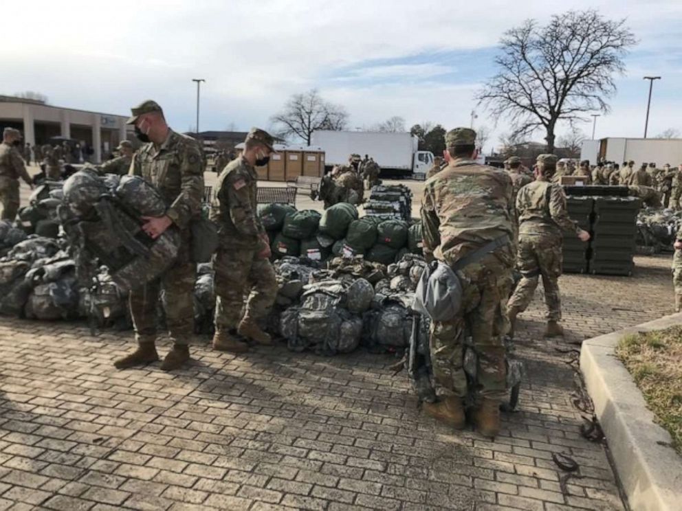 PHOTO: National Guardsmen at Joint Base Andrews, Maryland, ready their gear ahead after arriving at the base. They are part of the 25,000 National Guardsmen who will help provide security at the Presidential Inauguration.