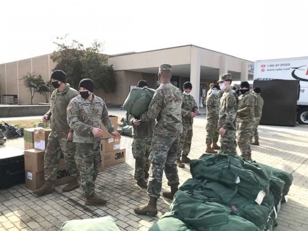 PHOTO: National Guardsmen at Joint Base Andrews, Maryland, ready their gear ahead after arriving at the base. They are part of the 25,000 National Guardsmen who will help provide security at the Presidential Inauguration.