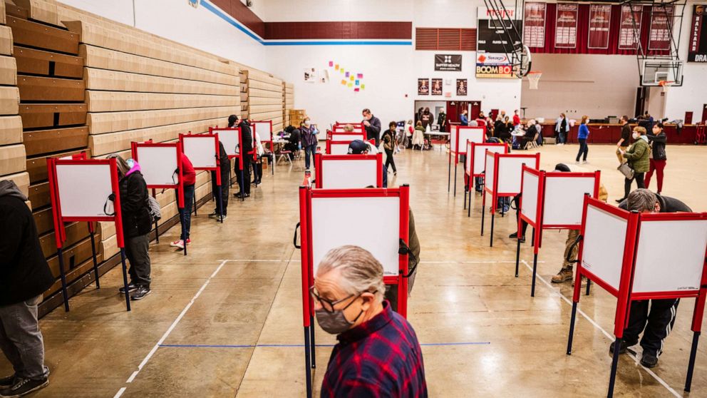 PHOTO: An election official stands near the ballot boxes at Ballard High School on Nov. 3, 2020 in Louisville, Ky.