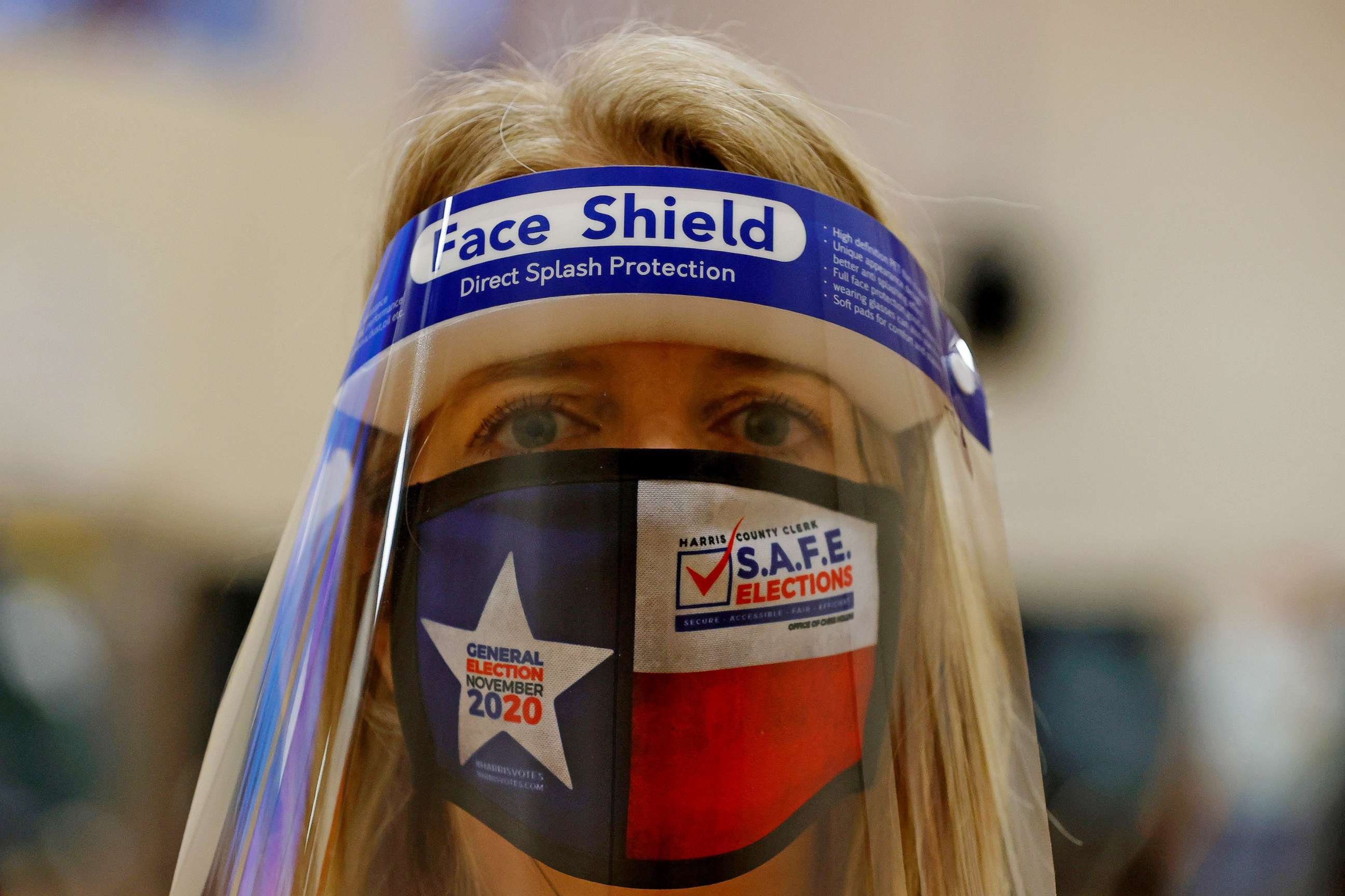 PHOTO: An election official wears a protective face shield at a polling location in Houston, Nov. 03, 2020.