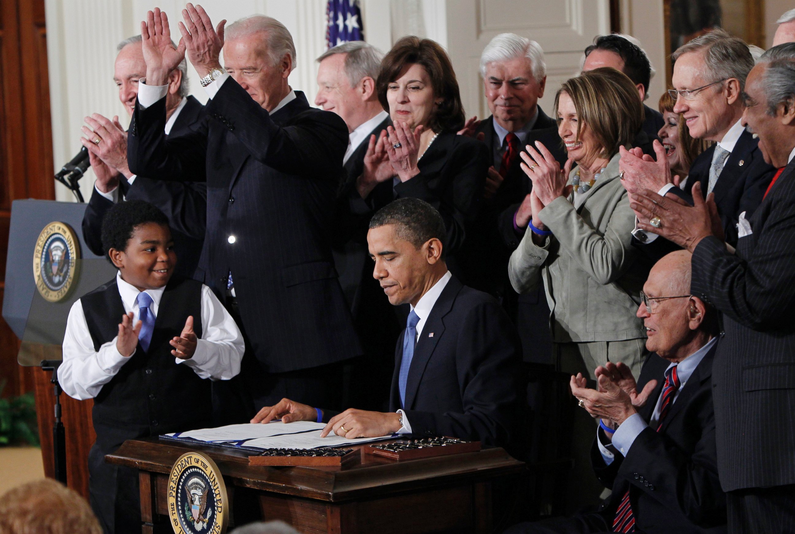 PHOTO: President Barack Obama is applauded after signing the Affordable Care Act into law in the East Room of the White House on March 23, 2010.  