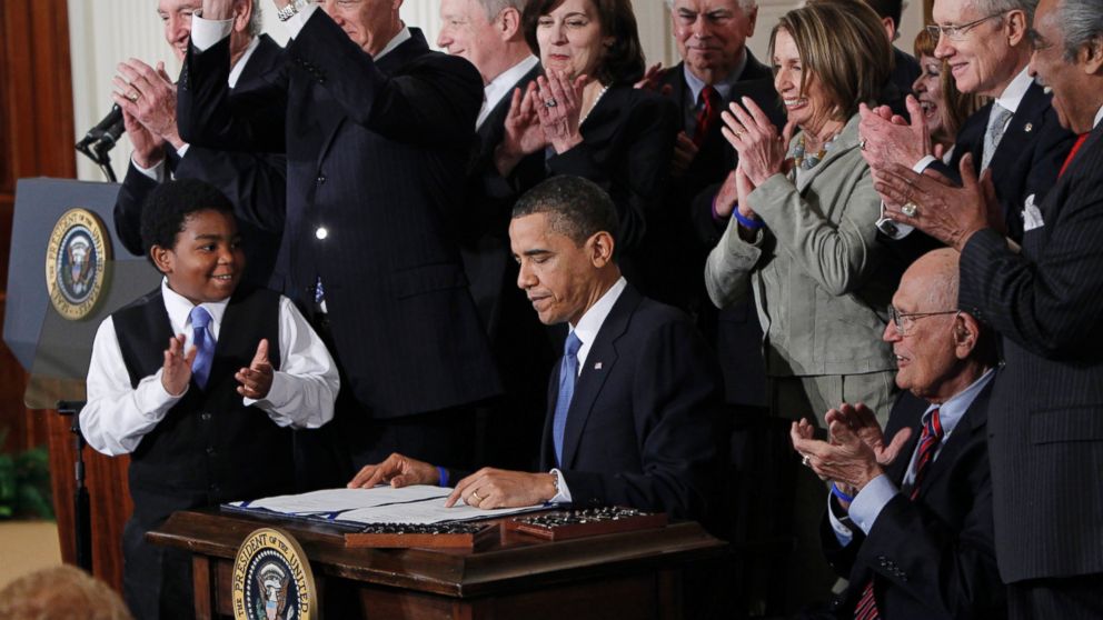 PHOTO: President Barack Obama is applauded after signing the Affordable Care Act into law in the East Room of the White House on March 23, 2010.  
