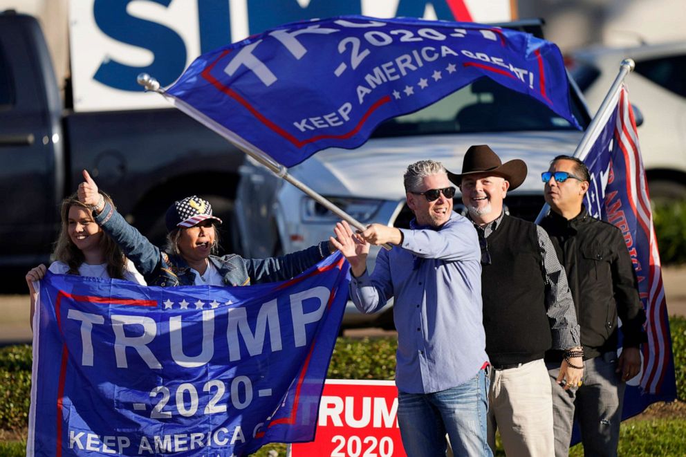PHOTO: Supporters of President Trump cheer as passing cars honk their horns near a polling location on Election Day, Nov. 3, 2020, in Houston.