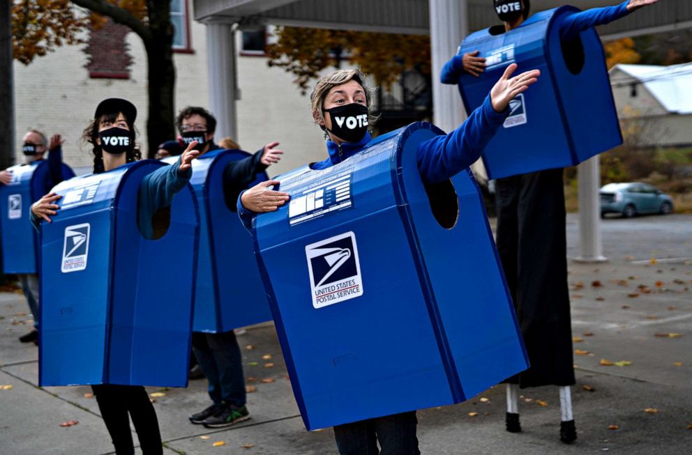 PHOTO: A group organized by the Farm Arts Collective and costumed as mailboxes dance and sing about voting in Honesdale, Pa., Oct. 24, 2020.