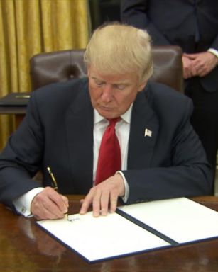 President Trump signs executive orders on his first night in the Oval Office.