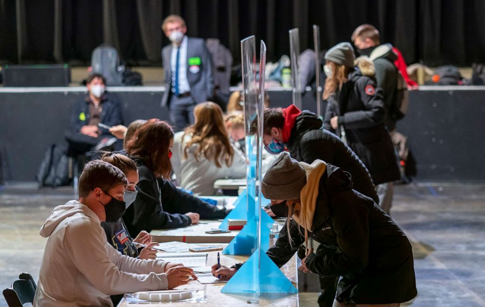 PHOTO: Poll workers check voters identifications at The Orpheum Theater on Nov. 3, 2020 in Madison, Wis.
