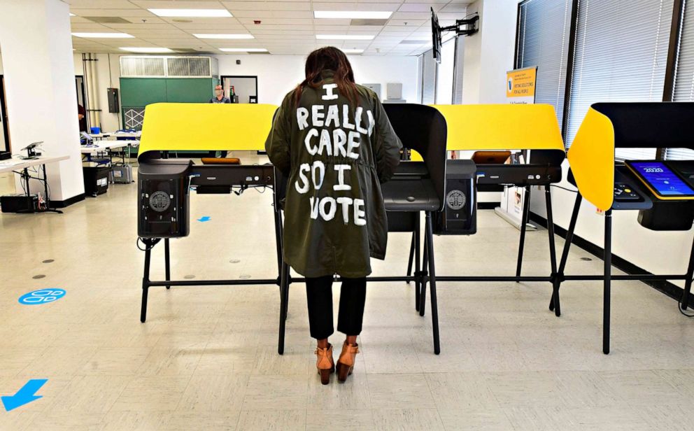 PHOTO: Wearing a coat reading "I Really Care So I Vote" written on the back, Tonya Swain votes in the 2020 elections at the Los Angeles County Registrar in Norwalk, Calif., on Oct. 19, 2020.
