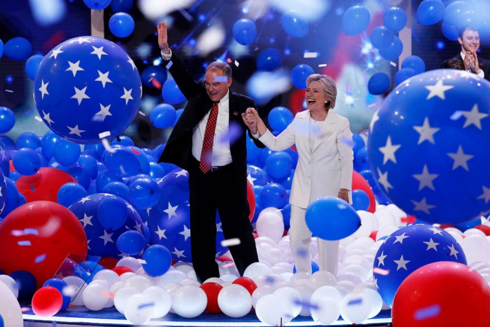 PHOTO: Democratic vice presidential nominee Sen. Tim Kaine and Democratic presidential nominee Hillary Clinton walk through falling balloons during the final day of the Democratic National Convention in Philadelphia, July 28, 2016. 