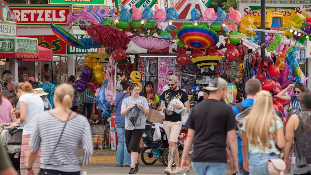 People walk near food kiosks at the Iowa State Fair, on Aug. 19, 2018 in Des Moines, Iowa.