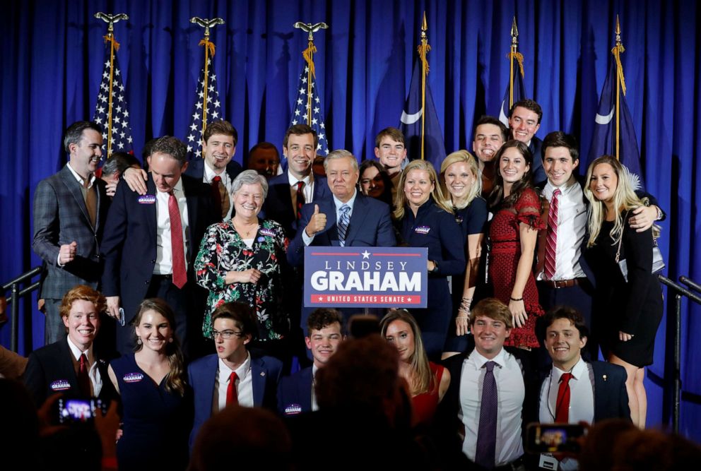 PHOTO: Sen. Lindsey Graham gives a thumbs-up as he takes a group picture at his election night party in Columbia, S.C., Nov. 3, 2020.