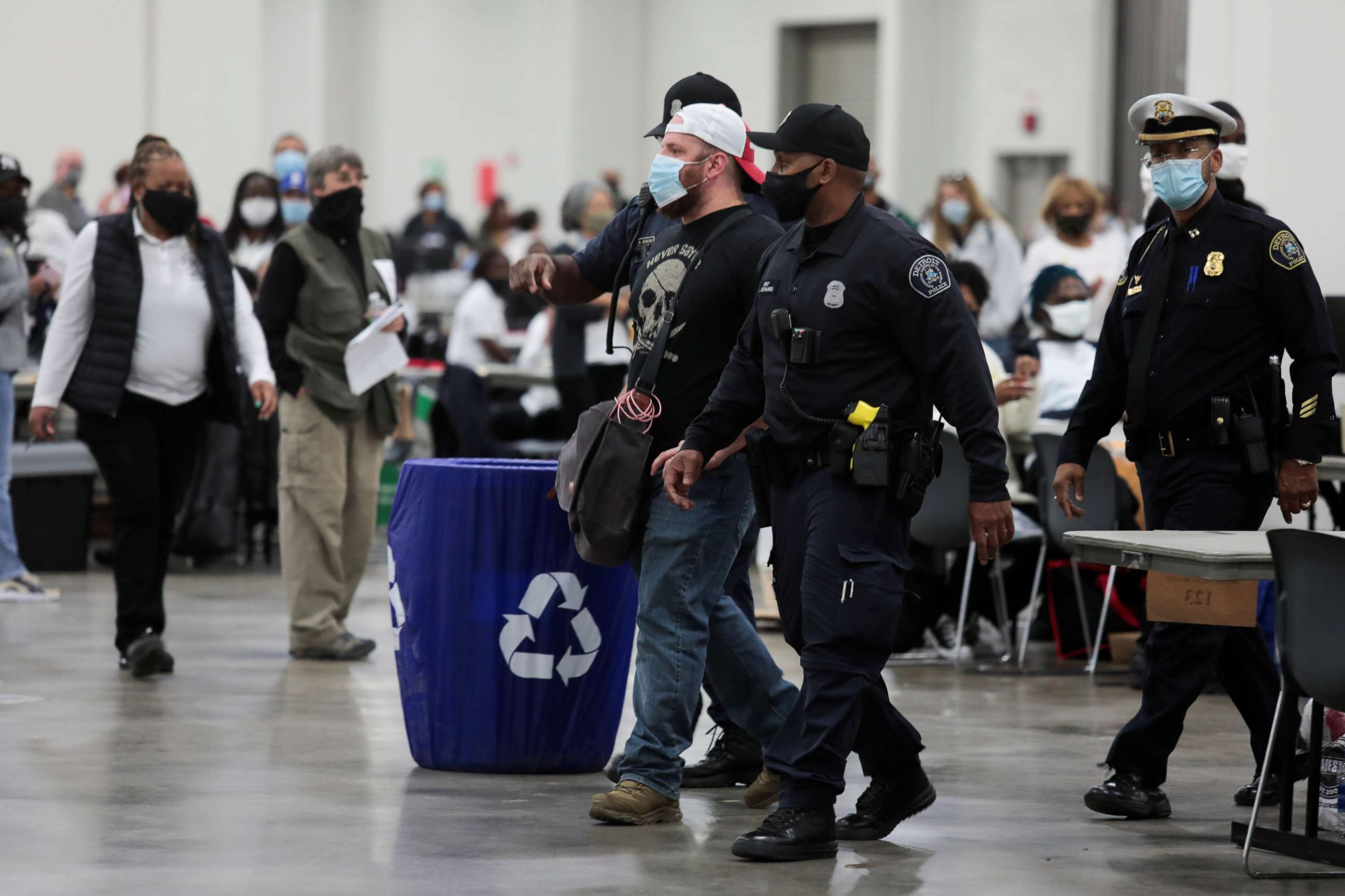 PHOTO: Detroit police escort a poll challenger out after he refused to leave, due to room capacity, at the TCF Center after election day in Detroit, Nov. 4, 2020.