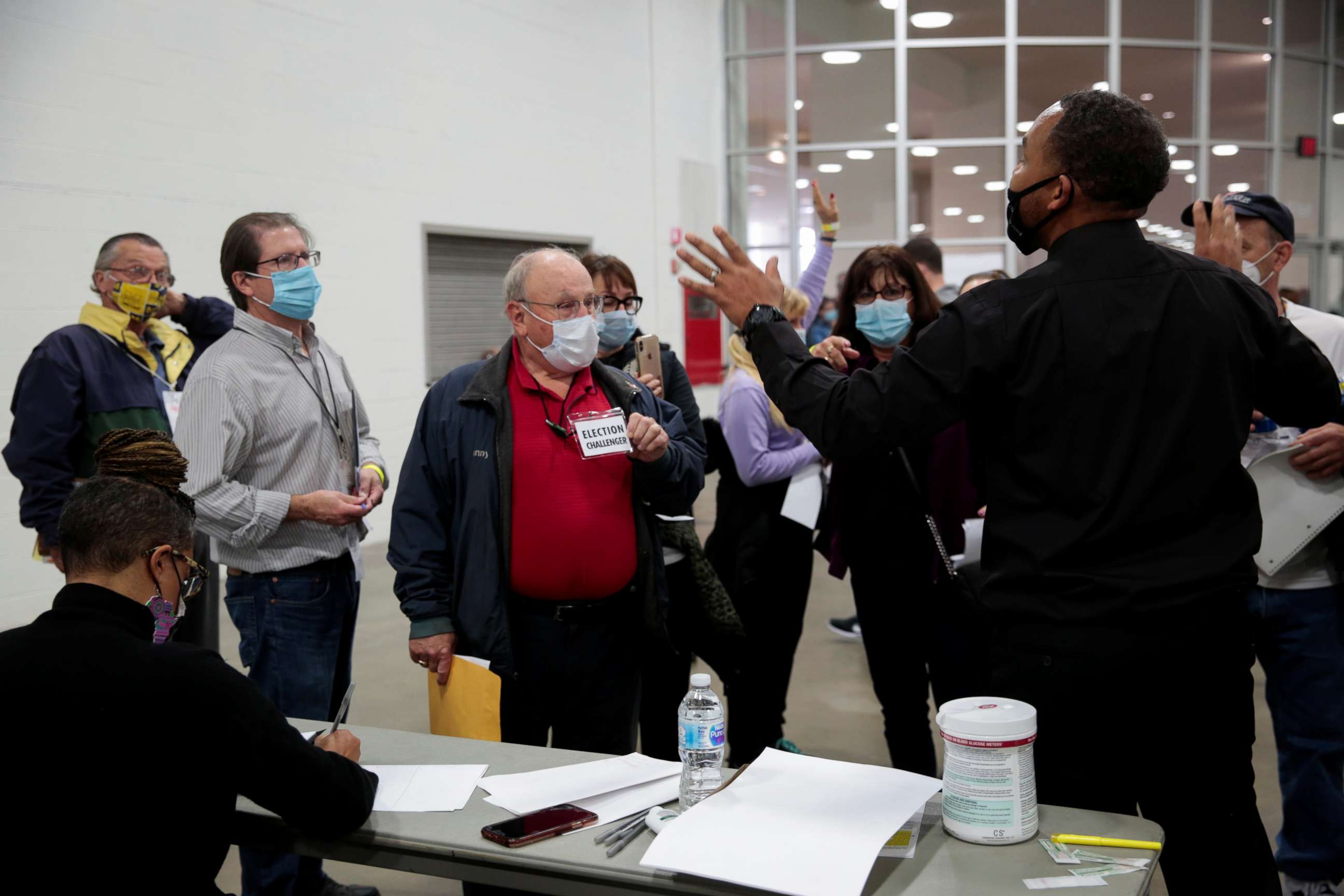 PHOTO: A poll challenger argues with police and officials after being asked to leave due to room capacity at the TCF Center after election day in Detroit, Nov. 4, 2020.