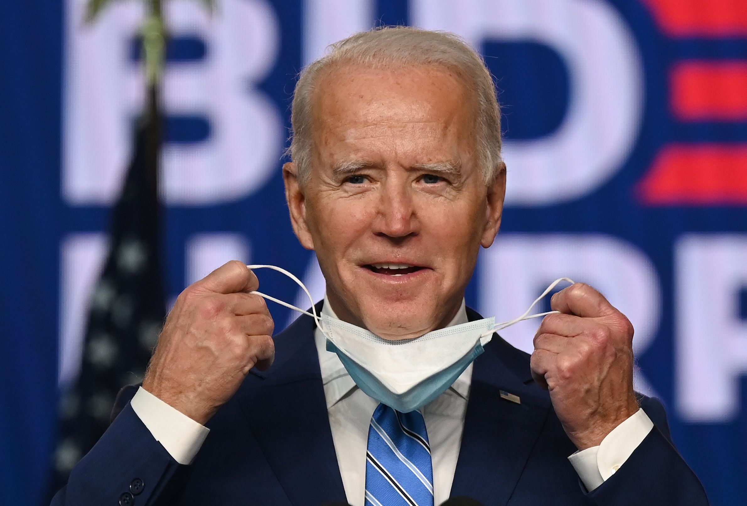 PHOTO: Democratic Presidential candidate Joe Biden removes his mask before speaking at the Chase Center in Wilmington, Del., Nov. 4, 2020.