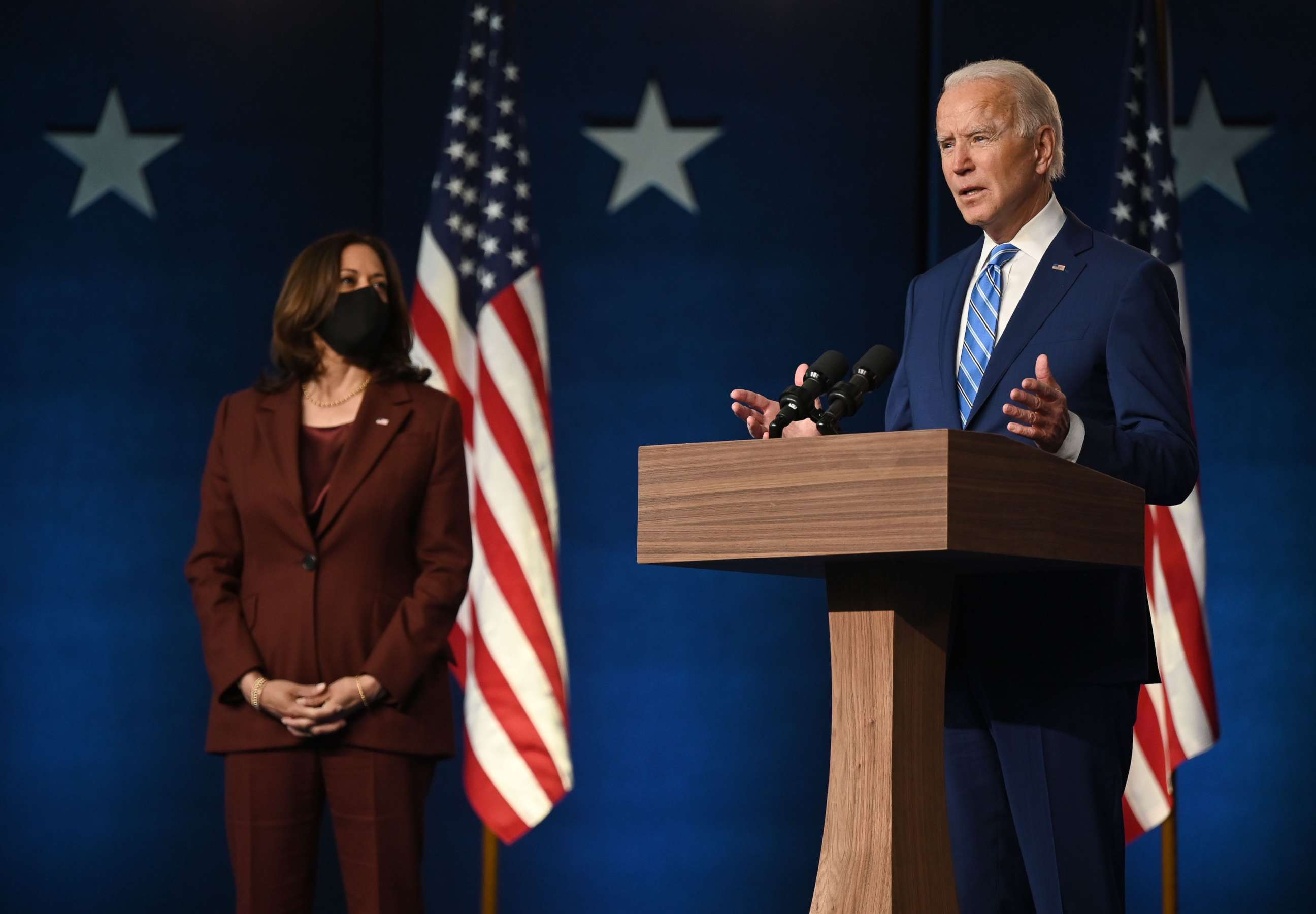 PHOTO: Democratic Presidential candidate Joe Biden speaks as Sen. and Vice-Presidential candidate, Kamala Harris, looks on at the Chase Center in Wilmington, Del., Nov. 4, 2020.