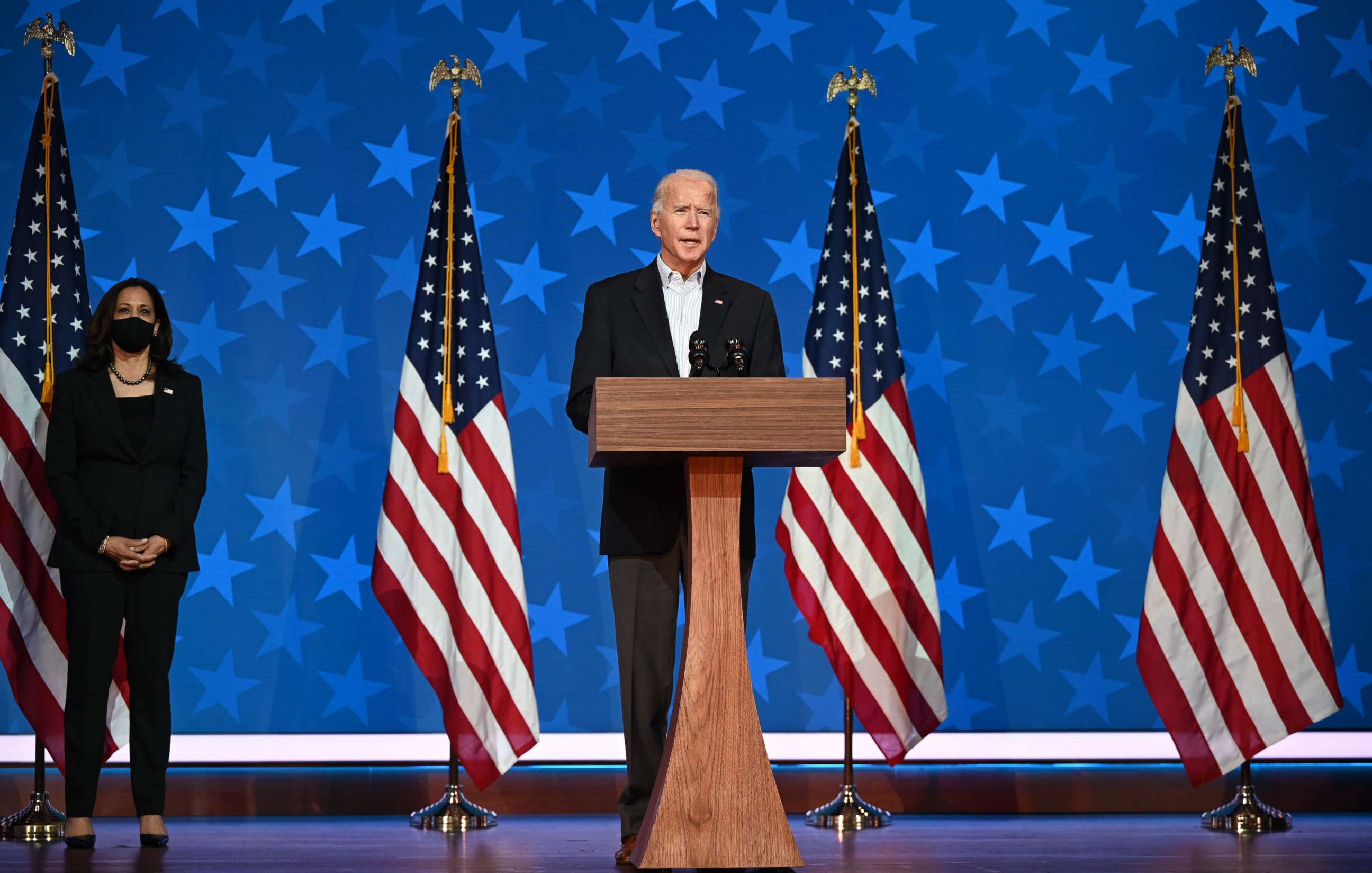 PHOTO: Democratic Presidential candidate Joe Biden speaks as Sen. and Vice-Presidential candidate, Kamala Harris, looks on at the Queen venue in Wilmington, Del., Nov. 5, 2020.