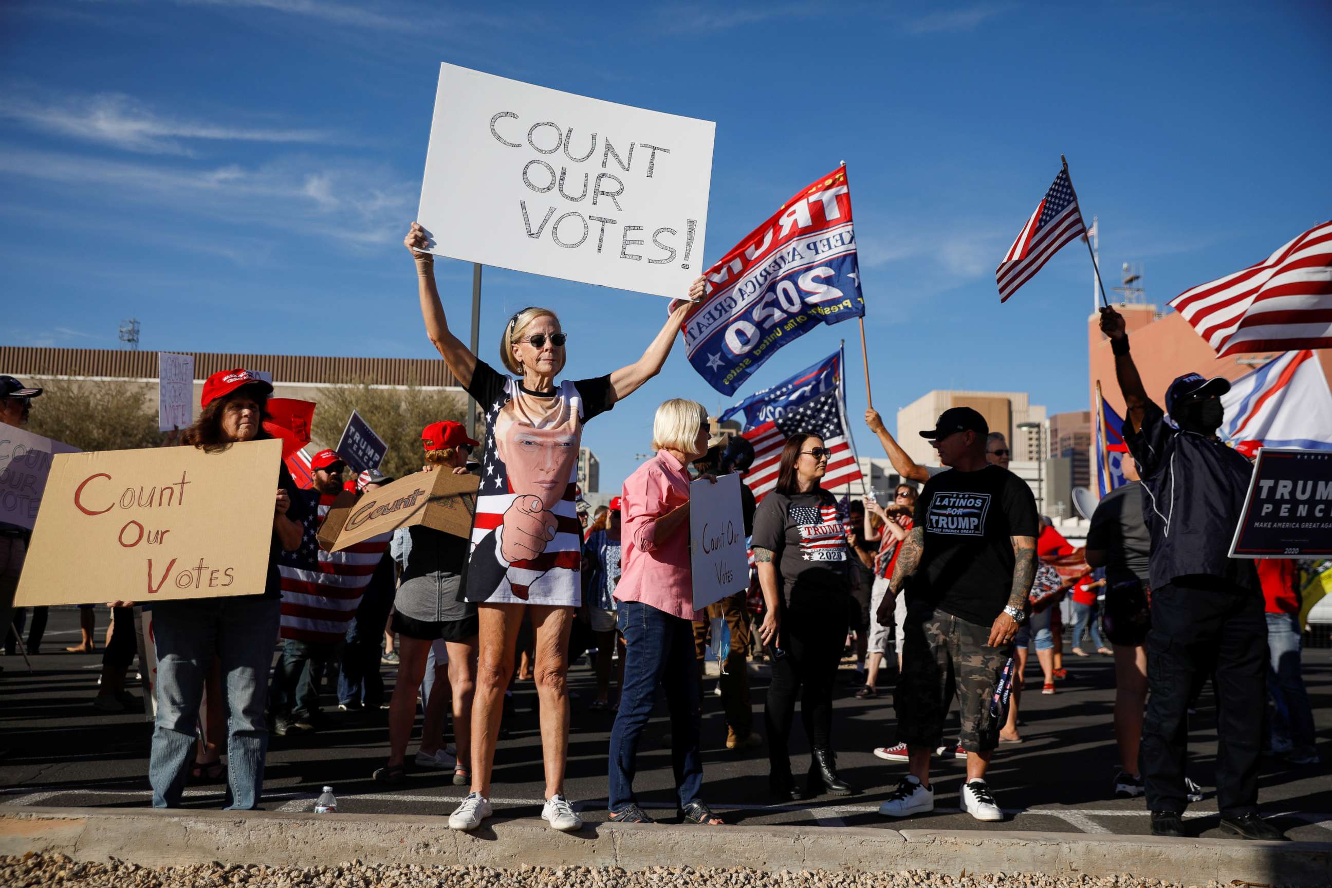 PHOTO: Supporters of President Donald Trump hold placards during a protest about the early results of the 2020 presidential election, in front of the Maricopa County Tabulation and Election Center in Phoenix, Nov. 5, 2020.