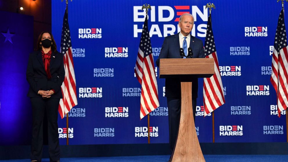 PHOTO: Democratic presidential nominee Joe Biden delivers remarks at the Chase Center in Wilmington, Del., while Sen. Kamala Harris watches, Nov. 6, 2020.
