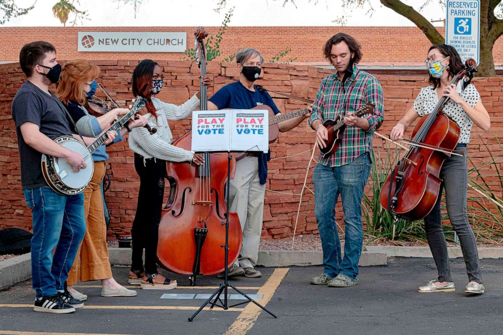 PHOTO: Musicians perform at the Burton Barr Library polling station as voters arrive to cast their ballots in Phoenix, Nov. 3, 2020.