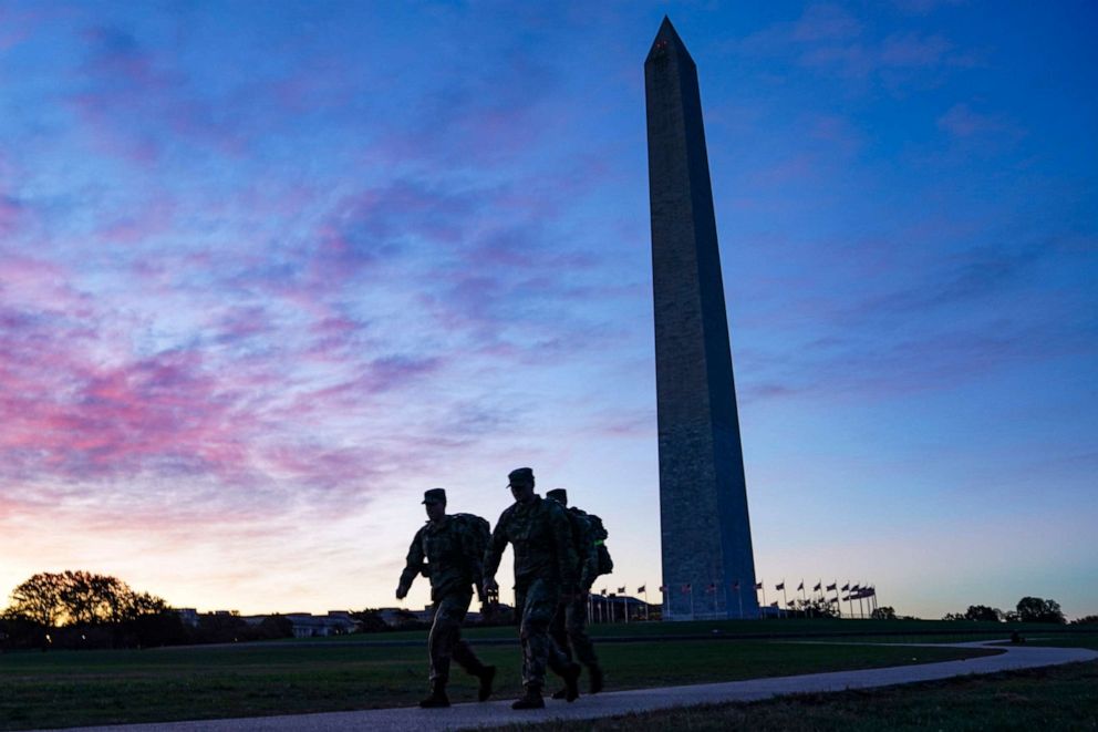 PHOTO: United States National Guard members walk towards the White House from the Washington Monument on Election Day, Nov. 3, 2020, in Washington.
