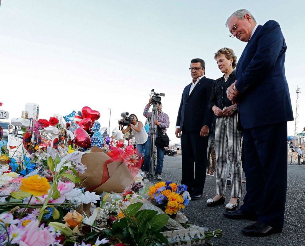 PHOTO: Juarez Mayor Armando Cabada, left, and El Paso Mayor Dee Margo, right, and his wife Adair, place flowers at the makeshift memorial outside the Walmart in El Paso, Texas, Aug. 7, 2019,  where a mass shooting took place.