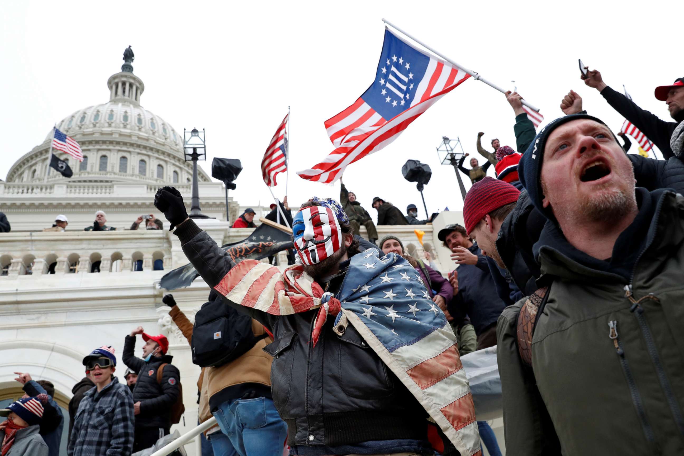 PHOTO: A Three Percenters flag is carried by people who broke into the Capitol grounds to  contest the certification of the 2020 U.S. presidential election results, at the U.S. Capitol Building in Washington, D.C., Jan. 6, 2021. 