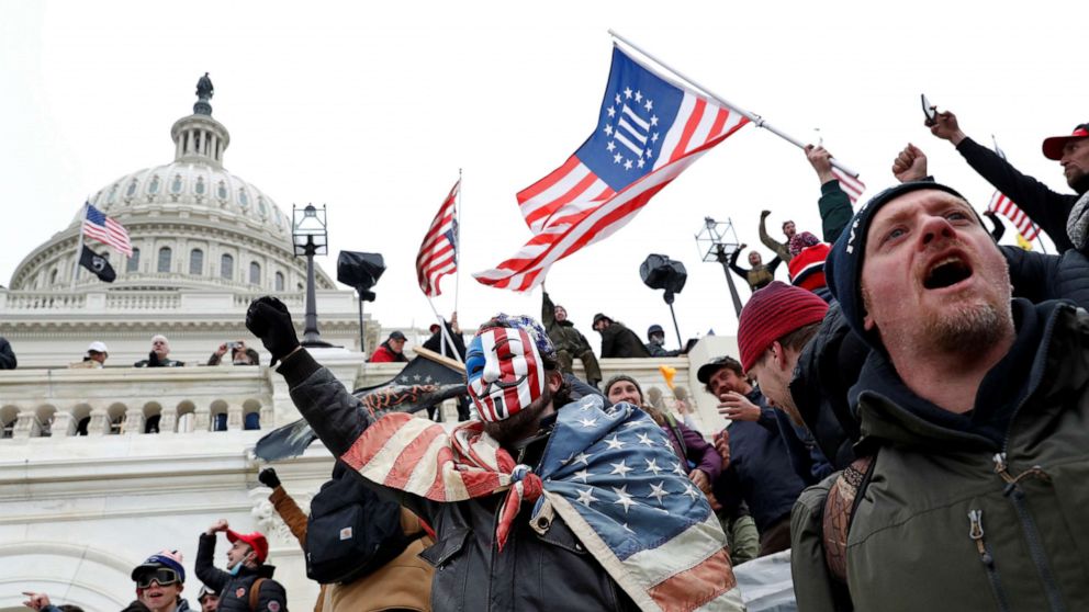 PHOTO: A Three Percenters flag is carried by people who broke into the Capitol grounds to  contest the certification of the 2020 U.S. presidential election results, at the U.S. Capitol Building in Washington, D.C., Jan. 6, 2021. 