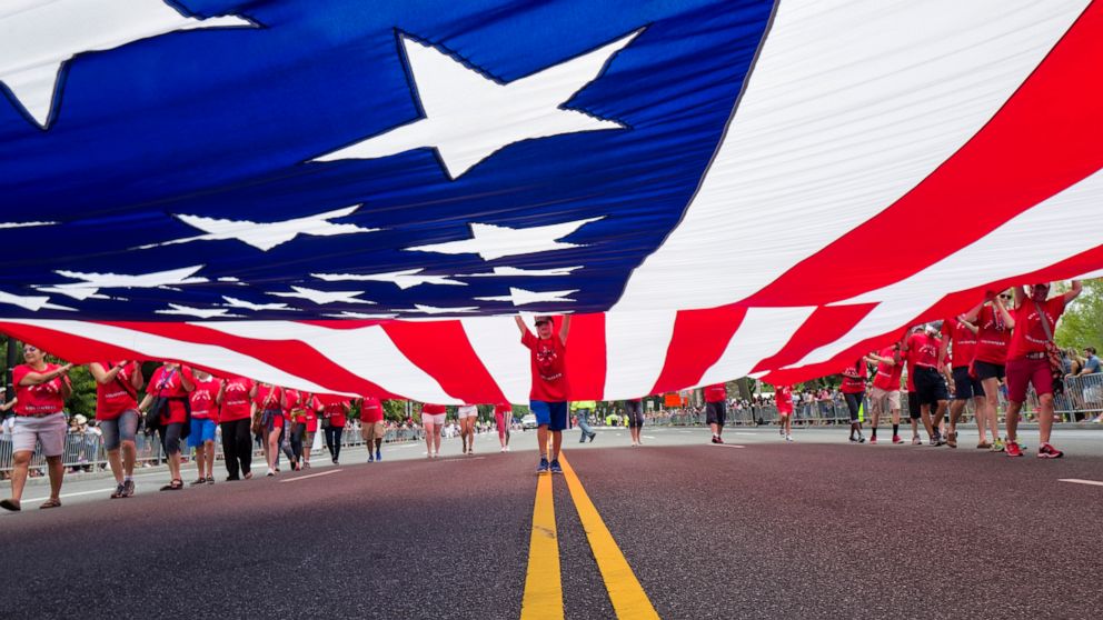PHOTO: A massive flag is carried along the Independence Day Parade route in Washington, July 4, 2015. 