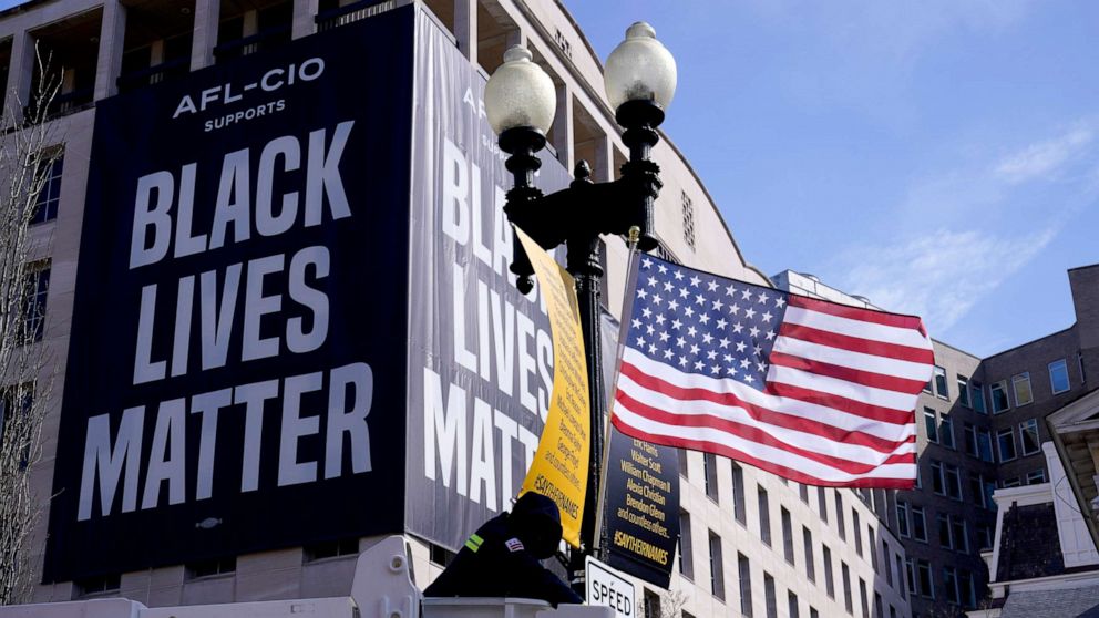 PHOTO: A flag is hung on Black Lives Matter Plaza in Washington, March 19, 2021, ahead of testimony next week by Washington, D.C., Mayor Muriel Bowser on D.C. statehood.