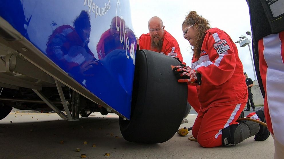 PHOTO: Ramp lead Cody Turner helps replace tire.