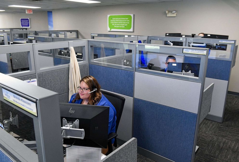 PHOTO: Helpline Center employees take calls in Sioux Falls, S.D., July 13, 2022.