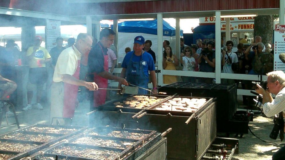 PHOTO: Mitt Romney flips pork chops at the Iowa State Fair, Aug. 2011.