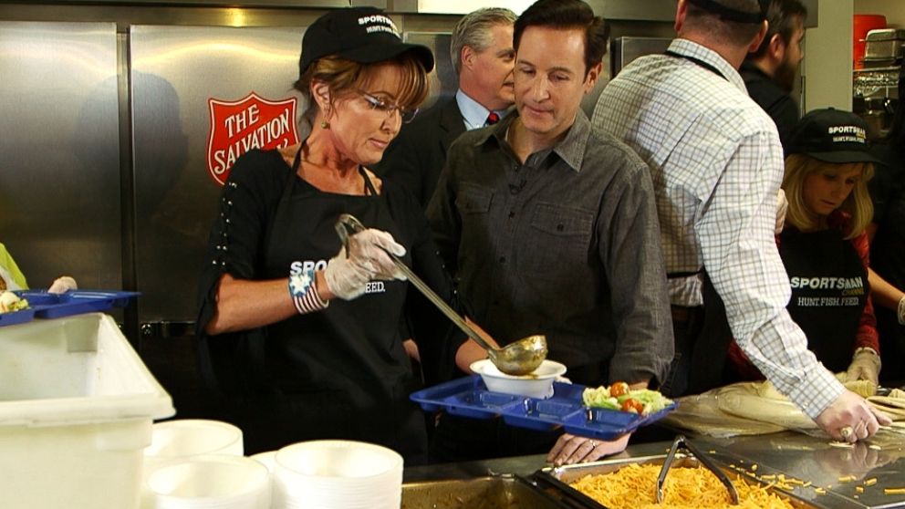 Sarah Palin and Neal Karlinsky are pictured as Palin serves wild boar chili to the homeless in Las Vegas. 