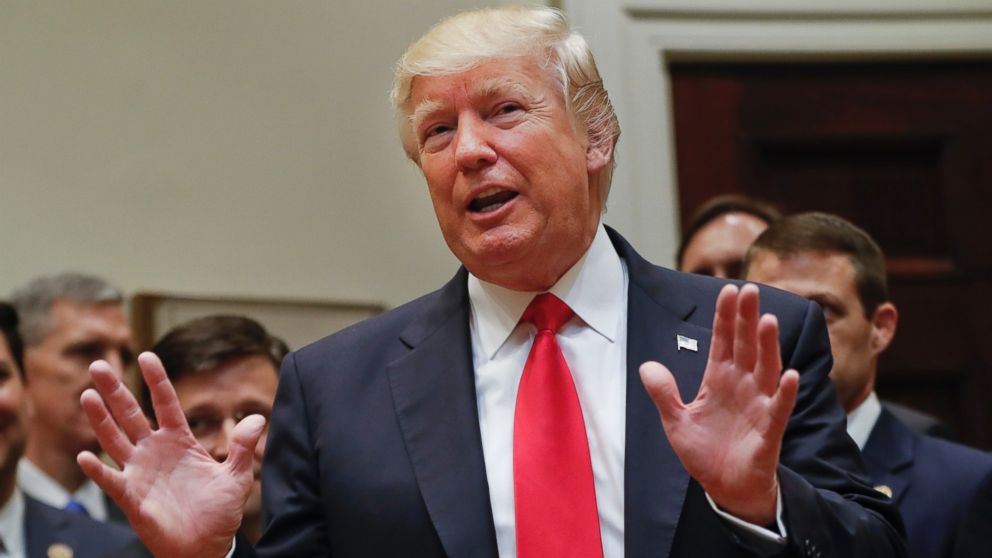 President Donald Trump gestures as he answers a question from a members of the the media after signing an Executive Order in the Roosevelt Room of the White House in Washington, on April 28, 2017.