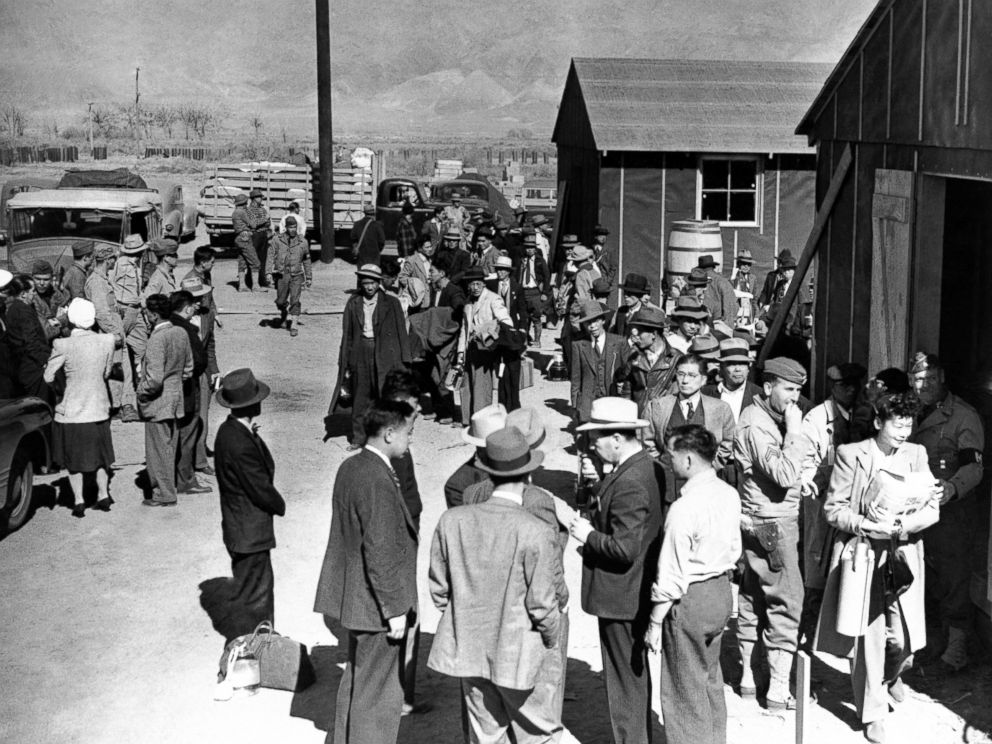 PHOTO: First arrivals at the Japanese evacuee community established in the owens valley at Manzanar, California, March 23, 1942, part of a vanguard of 86 workers from Los Angeles, are assigned to quarters in the barracks.
