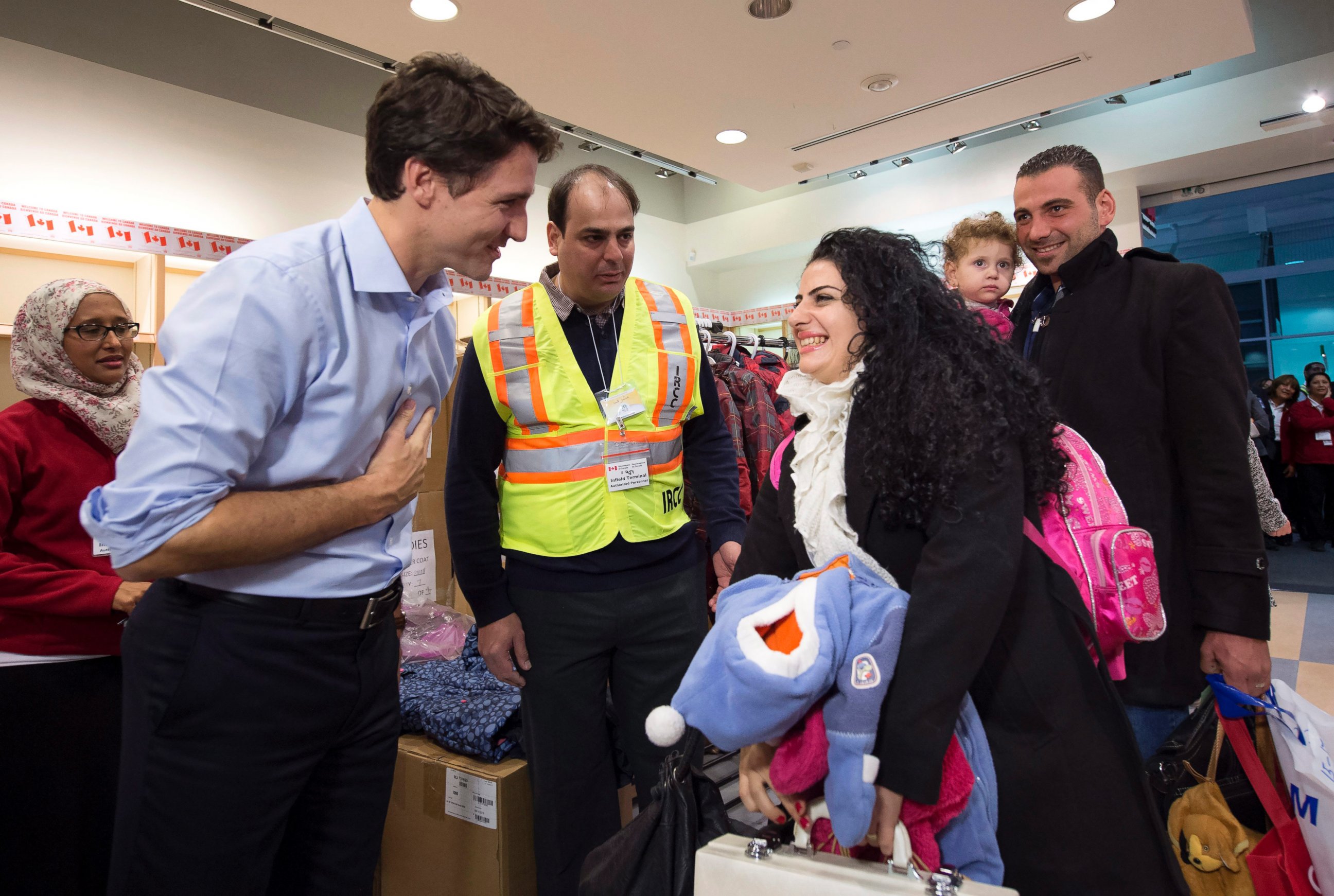 PHOTO: Canadian Prime Minister Justin Trudeau greets Syrian refugees Georgina Zires, center, Madeleine Jamkossian, second right, and her father Kevork Jamkossian as they arrive at Pearson International airport. Dec. 11, 2015, in Toronto.