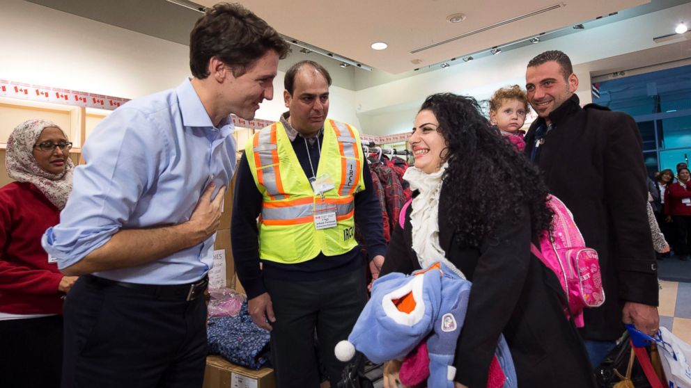 PHOTO: Canadian Prime Minister Justin Trudeau greets Syrian refugees Georgina Zires, center, Madeleine Jamkossian, second right, and her father Kevork Jamkossian as they arrive at Pearson International airport. Dec. 11, 2015, in Toronto.