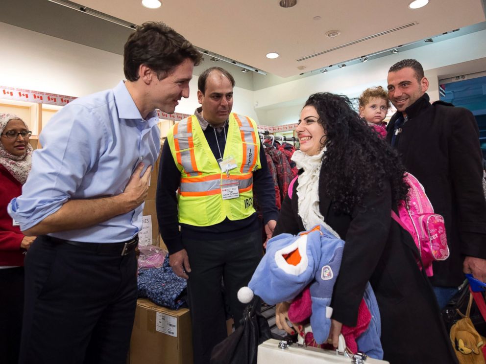 PHOTO: Canadian Prime Minister Justin Trudeau greets Syrian refugees Georgina Zires, center, Madeleine Jamkossian, second right, and her father Kevork Jamkossian as they arrive at Pearson International airport. Dec. 11, 2015, in Toronto.