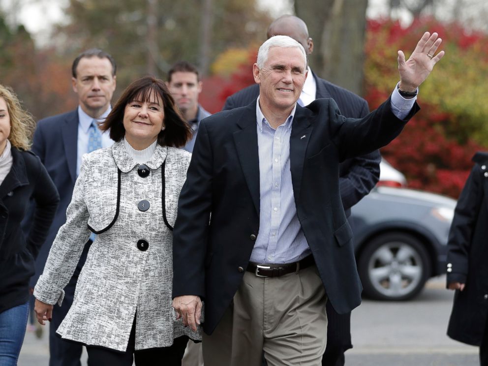PHOTO: Republican vice presidential candidate, Indiana Gov. Mike Pence, accompanied by his wife, Karen, waves as they go to cast their ballots, Nov. 8, 2016, in Indianapolis.
