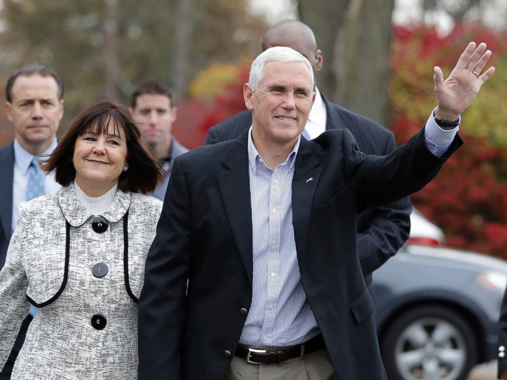 PHOTO: Republican vice presidential candidate, Indiana Gov. Mike Pence, accompanied by his wife, Karen, waves as they go to cast their ballots, Nov. 8, 2016, in Indianapolis.