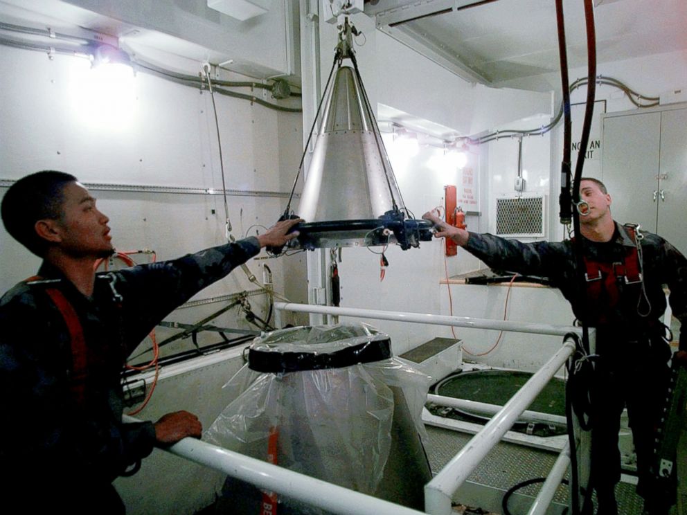 PHOTO: Senior Airmen Mark Pacis, left, and Christopher Carver mount a refurbished nuclear warhead on to the top of a Minuteman III intercontinental ballistic missile inside an underground silo in Scottsbluff, Neb., April 15, 1997.