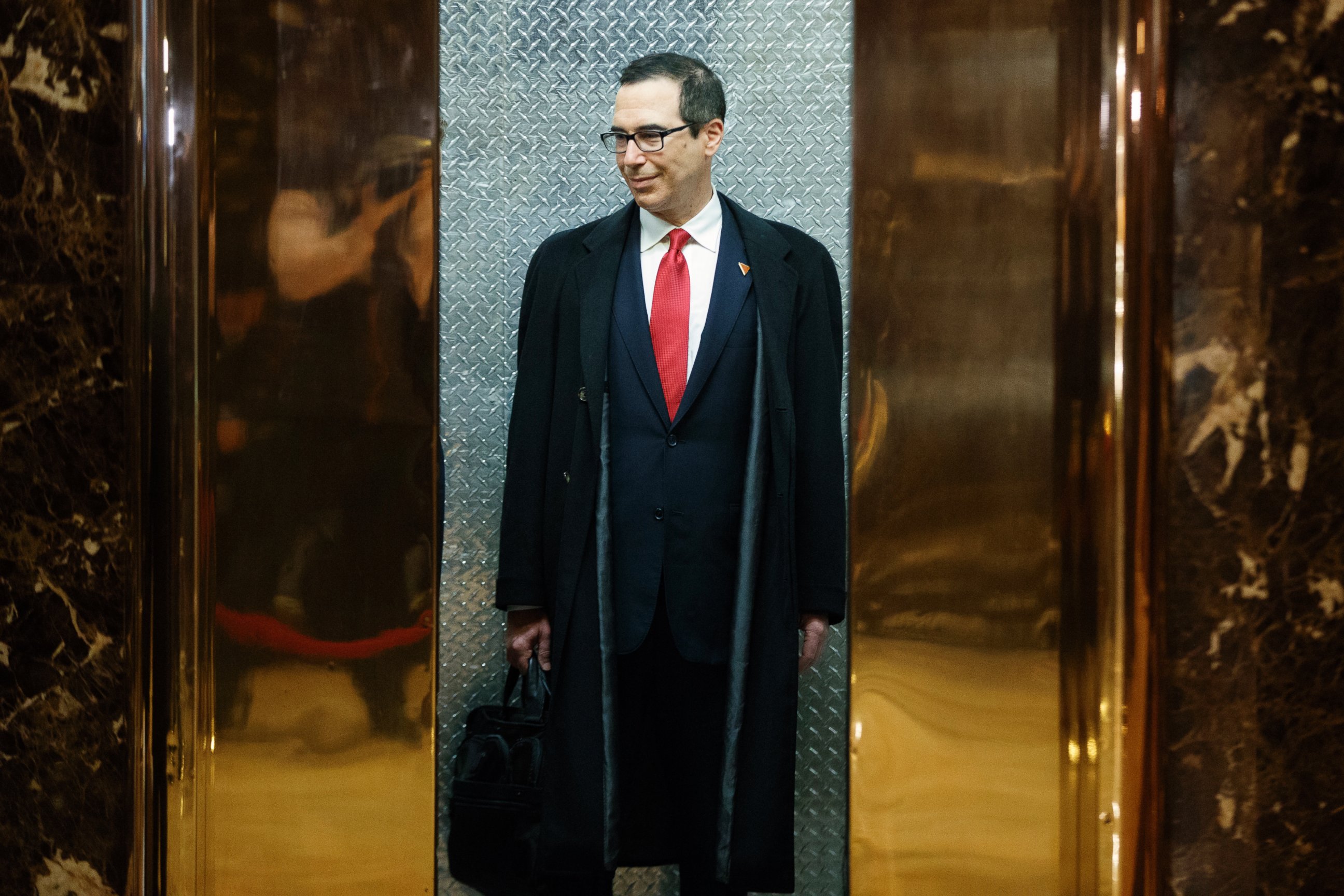 PHOTO: Steven Mnuchin, President-elect Donald Trump's nominee for Treasury Secretary, gets on an elevator after speaking with reporters in the lobby of Trump Tower, Nov. 30, 2016, in New York City. 