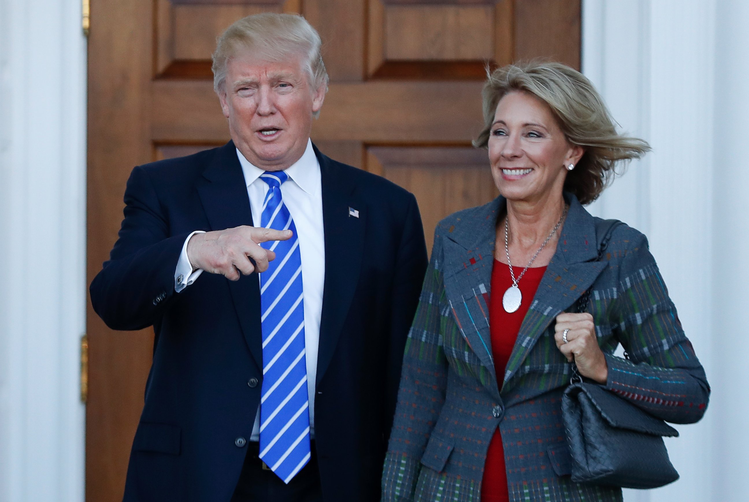 PHOTO: President-elect Donald Trump and Betsy DeVos pose for photographs at Trump National Golf Club Bedminster clubhouse in Bedminster, New Jersey, Nov. 19, 2016.