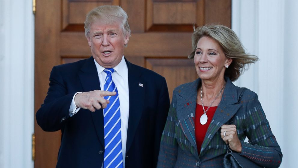 PHOTO: President-elect Donald Trump and Betsy DeVos pose for photographs at Trump National Golf Club Bedminster clubhouse in Bedminster, New Jersey, Nov. 19, 2016.
