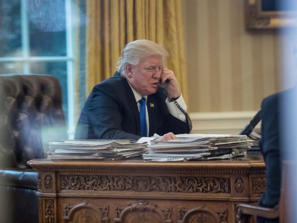PHOTO: President Donald Trump speaks on the phone with German Chancellor Angela Merkel, Jan. 28, 2017, in the Oval Office at the White House in Washington.