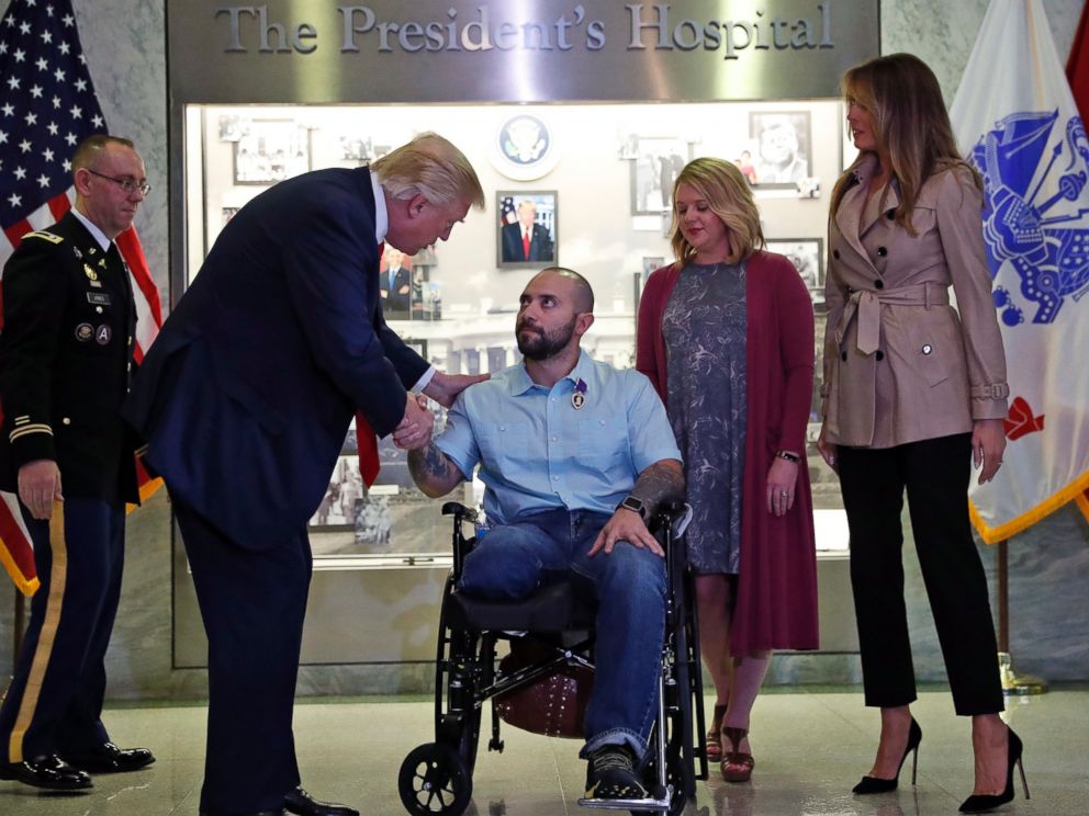 PHOTO: President Donald Trump shakes hands with U.S. Army Sgt. First Class Alvaro Barrientos, after awarding him with a Purple Heart, at Walter Reed National Military Medical Center, April 22, 2017, in Bethesda, Md.