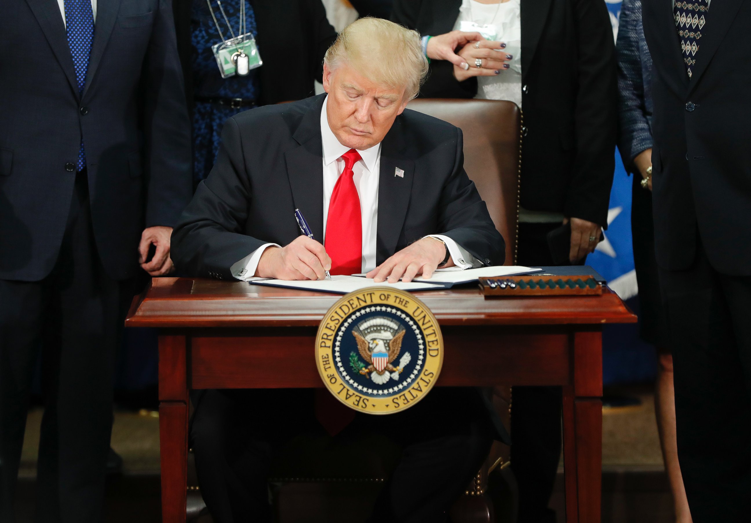 PHOTO: President Donald Trump signs an executive order for border security and immigration enforcement improvements at the Department of Homeland Security in Washington, Jan. 25, 2017. 